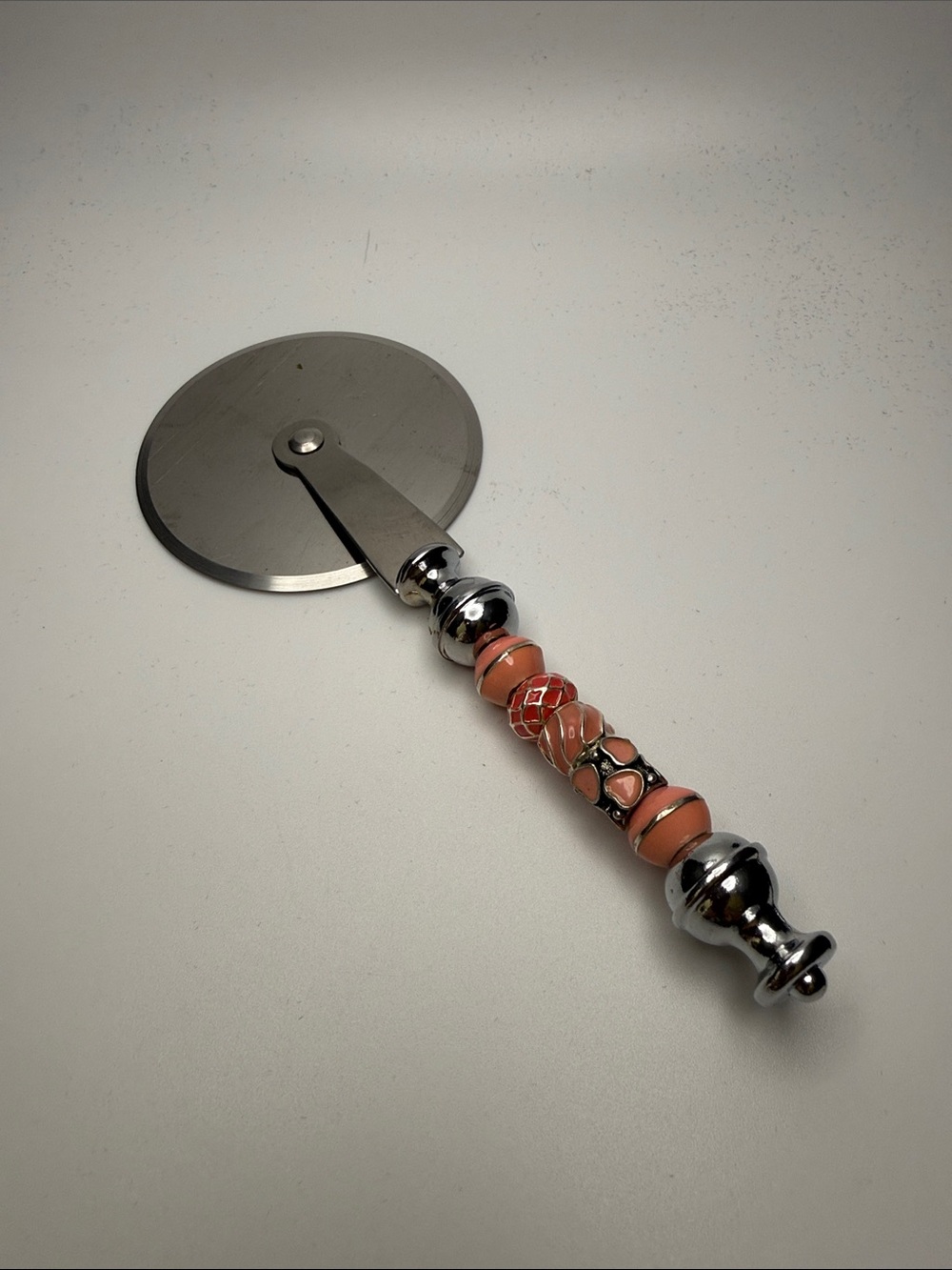Decorative Coral-Peach Beaded Pizza Cutter with Chrome Handle